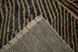 Corner of the Afghani carpet showing its hand-knotted foundation and tightly woven back.