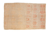 Distressed Turkish Oushak carpet with heavily faded geometric blossoms in blush and sand tones.