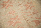 Distressed texture of a vintage Oushak carpet showing low pile, knot heads, and blush geometric blossoms.