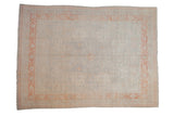Distressed Pakistani Khotan carpet with a soft silver field and pale terracotta border featuring tone-on-tone medallions.