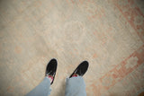 Evenly distressed low pile of a Khotan carpet in soft platinum and pale terracotta hues.