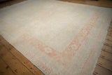 A long view across the distressed Khotan carpet's soft, even wear.