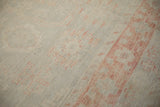 Even wear on the low pile of a distressed Khotan carpet with soft terracotta patterns.