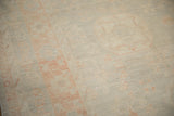 Distressed hand-knotted texture showing even wear across soft terracotta and silver tones.