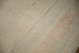 Close view of the distressed carpet's low pile, revealing its even, hand-knotted texture.