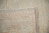 Hand-knotted construction and sewn-on side binding on the reverse of a Pakistani Khotan carpet.