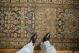 Top-down view of the time-softened Herati motif and even wear on a distressed Hamadan rug runner.