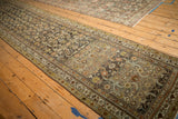 Angled view of a vintage Hamadan runner's allover Herati pattern with a time-softened patina.