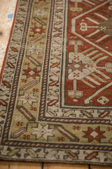 Close-up of the geometric starburst border in tones of rust, ochre, and charcoal.