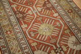 Intricate starburst motif and time-softened low pile of an antique Caucasian rug runner.