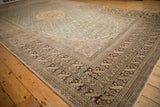 Angled perspective of a vintage Sivas carpet showing the dusty teal field and decorative sand borders.