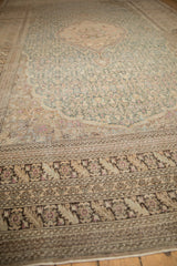 Low angle on a distressed Sivas carpet highlighting its time-softened pile and floral border.