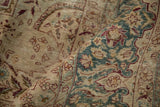 Worn texture of the hand-knotted pile on a Kerman's dusty teal dragon-style border.