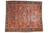 Antique Heriz carpet with interconnected vines forming a geometric lattice design in brick red and navy blue.