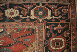 Close view of the antique Heriz carpet's corner showing the Samovar turtle and serpent design borders.