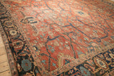 Angled view of the antique Heriz carpet's corner, highlighting the navy Samovar border and low pile.