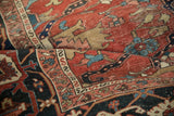Folded antique Heriz carpet highlights the Samovar turtle border motif and textured low pile.