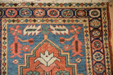 Fringed corner of antique Northwest Persian rug with serrated leaves and pomegranate border.