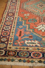 Antique Northwest Persian runner's navy blue pomegranate border with brick red field and fringe.