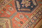 Antique Northwest Persian runner with brick red floral field and sapphire pomegranate border.