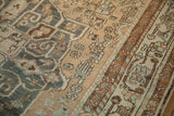 Abrashed dusty blue and sand floral patterns next to the copper and brown geometric border.
