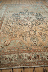 Low angle view down the heavily abrashed field of a vintage distressed Baktiari rug.