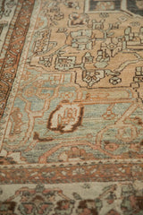 Angled view of the low pile texture and white knots on a distressed Bakhtiari carpet.