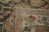 Corner of a distressed Baktiari showing its hand-knotted foundation and machine-bound edge.