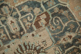 Close-up of the Baktiari carpet's hand-knotted texture, showing white knots in the floral design.