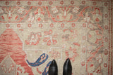 Detail of the low, distressed pile on a vintage Oushak, highlighting a navy blue boteh motif.