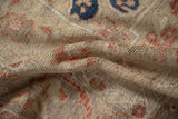 Close view of a vintage Oushak carpet's hand-knotted texture and mostly even wear.