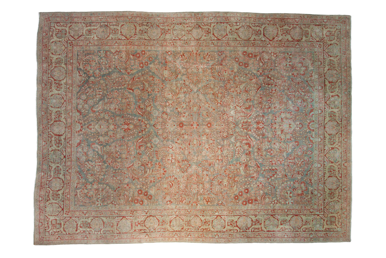 Antique distressed Sarouk carpet with allover floral and palmette border in slate blue, pomegranate.