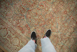 Antique distressed Sarouk carpet's allover floral pattern in slate blue and pomegranate red.
