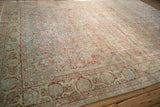 Distressed Sarouk rug corner, worn palmette border, floral field, slate blue, red, ivory hues.