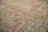 Textured pile of antique Distressed Sarouk carpet, revealing worn floral sprays and a partial arabesque border.