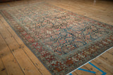 Angled view of a vintage Hamadan runner showing its time-softened colors and intricate Herati pattern.
