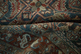 A detailed shot of the vintage Hamadan rug's low pile, revealing textural wear and color abrashes.