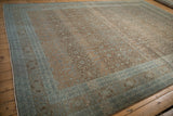 Distressed Hereke carpet with abrashed coffee brown field, pale blue florals, and arabesque border.