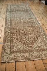 Vintage Hamadan runner seen from an angle, showing the soft fading of its Herati pattern.