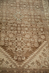 Angled close-up of a distressed Hamadan runner showing mostly even wear across the Herati motif's low pile.