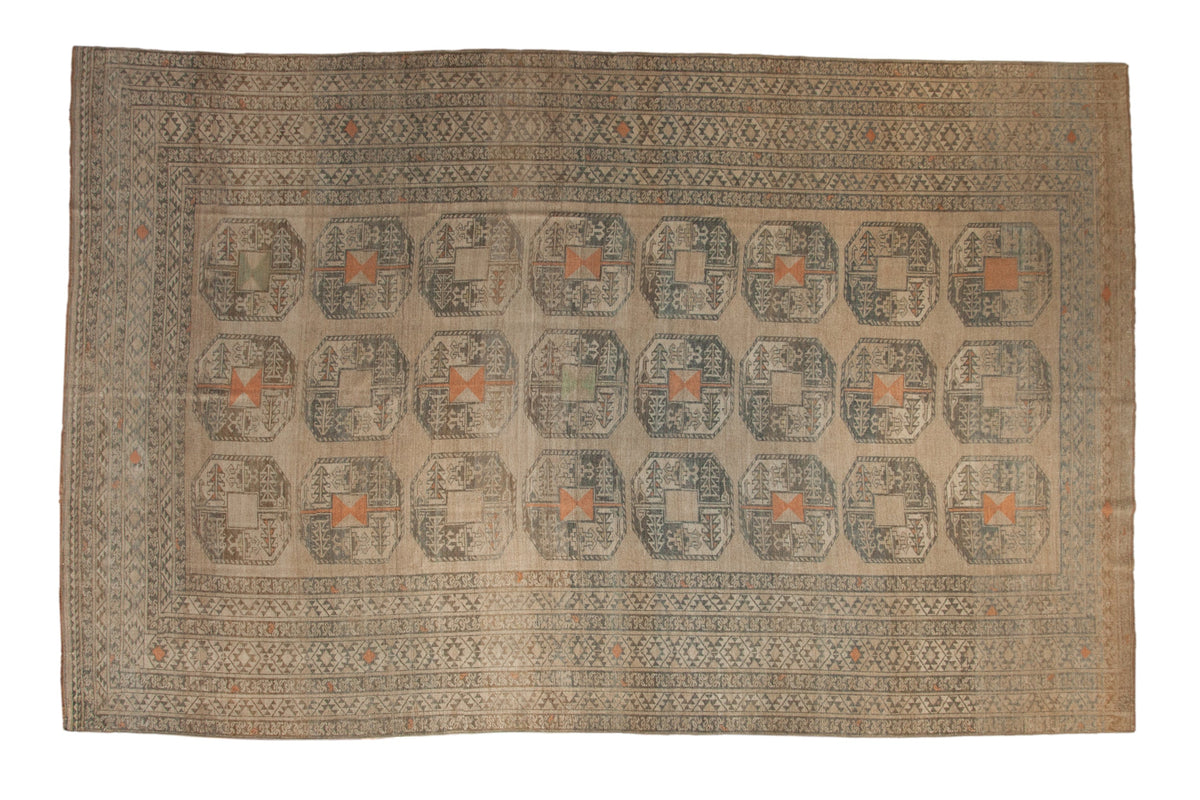 Vintage distressed Ersari carpet with elephant foot guls in camel, dusty teal, and pale orange.