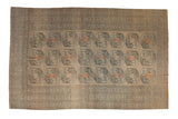 Vintage distressed Ersari carpet with elephant foot guls in camel, dusty teal, and pale orange.