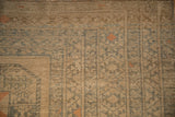 Geometric snowflake border detail on a distressed Ersari carpet with even, low-pile wear.