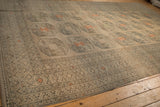 Long perspective of a distressed Ersari carpet, highlighting its low pile and geometric gul motif.