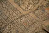 Evenly worn texture and geometric snowflake border on a draped vintage Ersari carpet.
