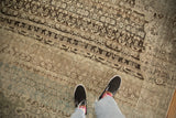Even wear across the pile reveals the knot heads of this distressed Bijar carpet.