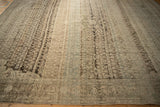 Heavy color abrashes and even wear seen in an angled view of a distressed Bijar carpet.