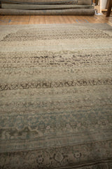 Heavy horizontal abrash in dusty teal, sand, and charcoal on a distressed Bijar rug.