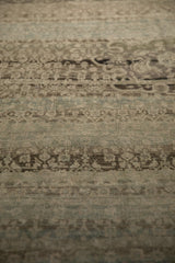 Heavy abrashes and even wear across the textured pile of a vintage Bijar.