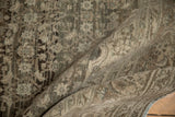 The supple texture and dense hand-knotted pile of a distressed Bijar carpet shown draped.